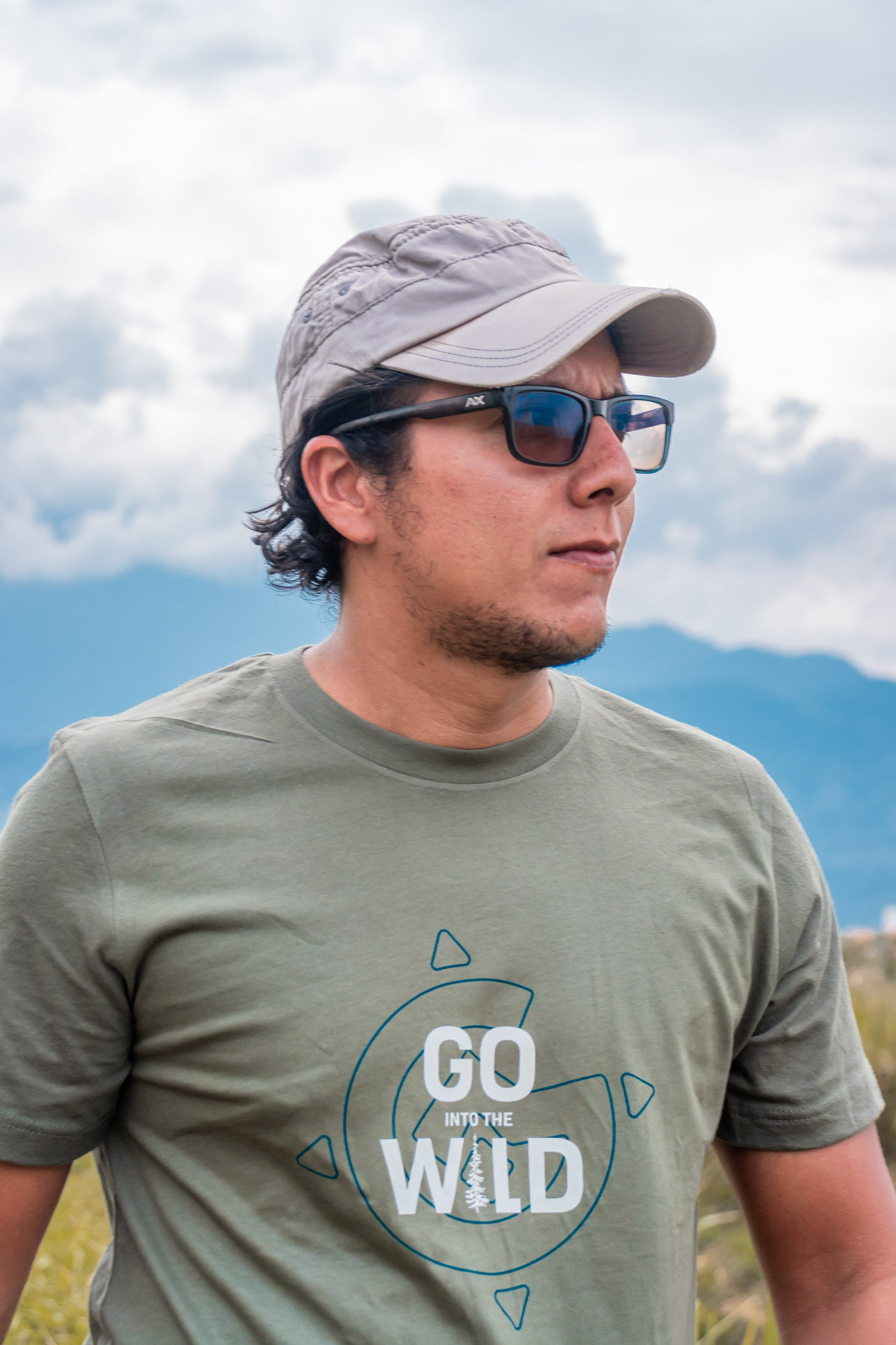 Man standing outside with a GoGrava T-shirt that says Go into the wild