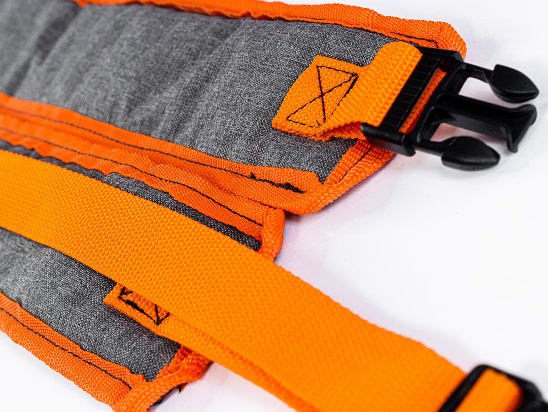 a close up picture of the buckles and quality, handmade stitching on the backpack shoulder strops.