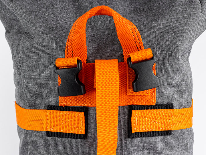 close up view of the top carry handle of the backpack to showcase the quality of the stitching .  You can also see the quality of the buckles for the shoulder straps.  In this image, there is also the ability to view the quality of the stitching for the wrap around straps that help you buckle your Backpack to any time to carry or to strap it to a bicycle.