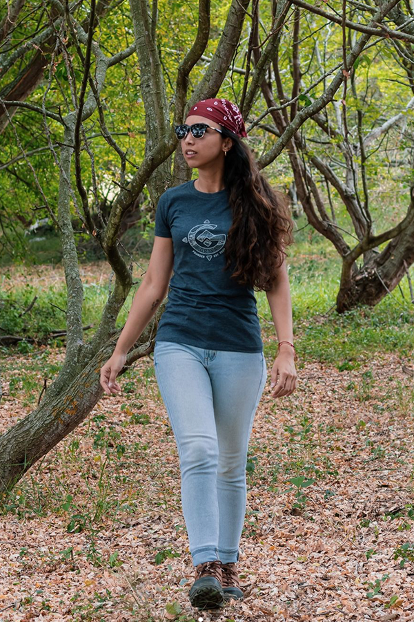 Woman walking outside with a Go Grava T-shirt