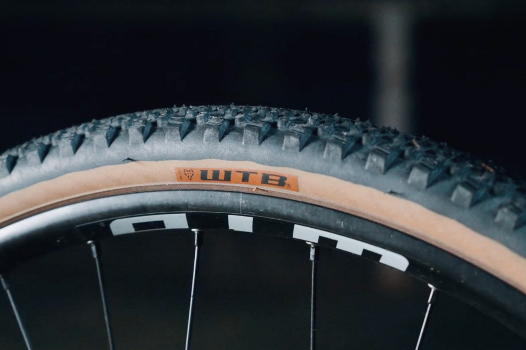 Close-up of a bicycle tire with WTB branding on a dark background
