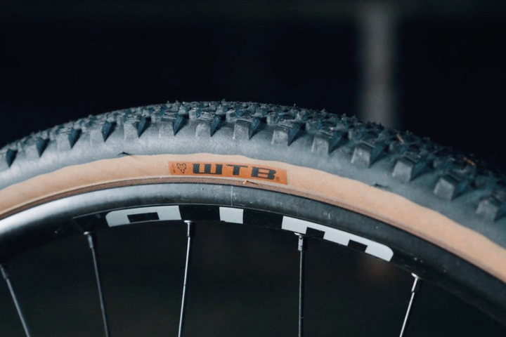 Close-up of a bicycle tire with WTB branding on a dark background