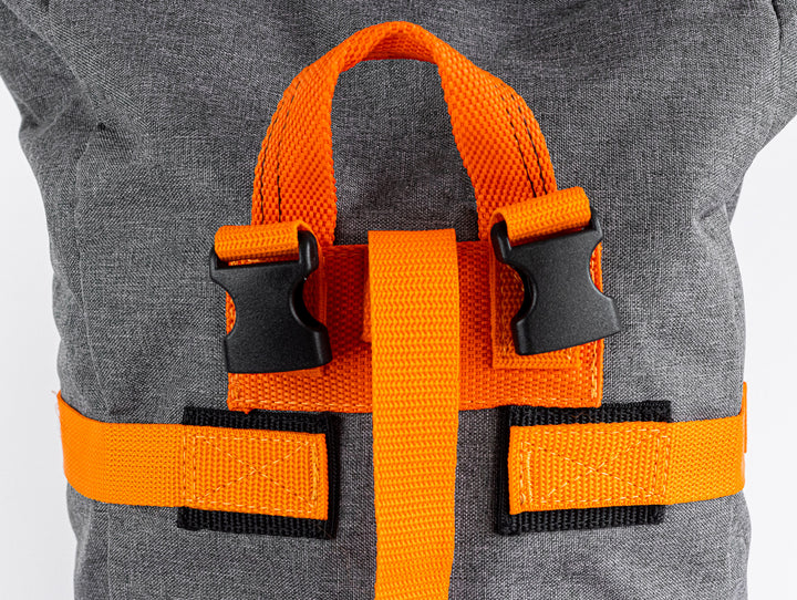 close up view of the top carry handle of the backpack to showcase the quality of the stitching .  You can also see the quality of the buckles for the shoulder straps.  In this image, there is also the ability to view the quality of the stitching for the wrap around straps that help you buckle your Backpack to any time to carry or to strap it to a bicycle. 