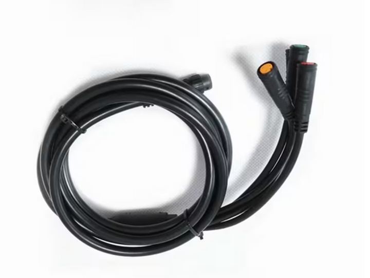 Coiled black cable with connectors on a white background