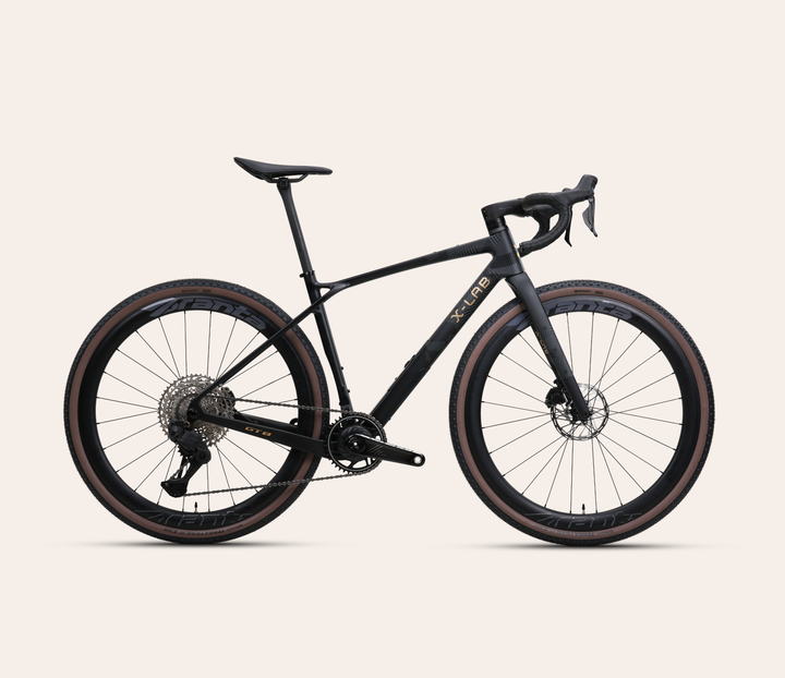 X-LAB GT8 Shimano GRX Di2 gravel bike in Afterburner Black, full bicycle drive-side view on a pale warm-neutral background