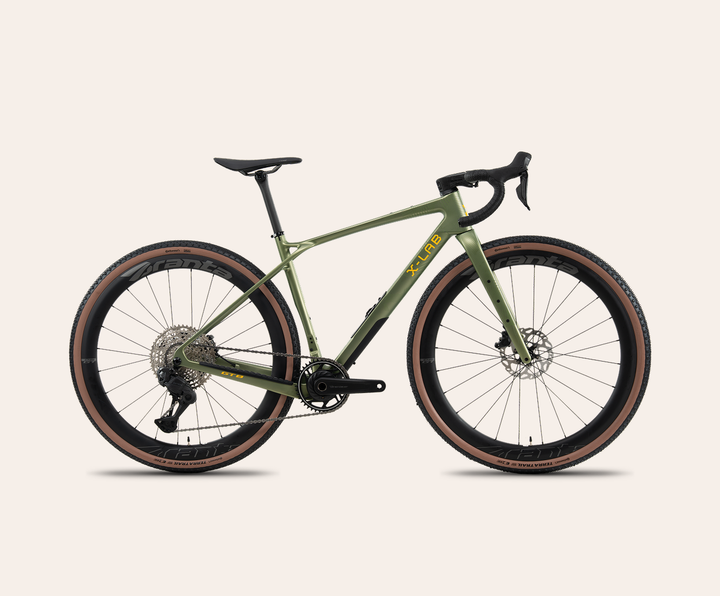 X-LAB GT8 Shimano GRX Di2 gravel bike in Recon Green, full bicycle drive-side view on a pale warm-neutral background