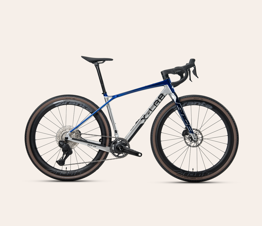 X-LAB GT8 Shimano GRX Di2 gravel bike in Slipstream, full bicycle drive-side view on a pale warm-neutral background