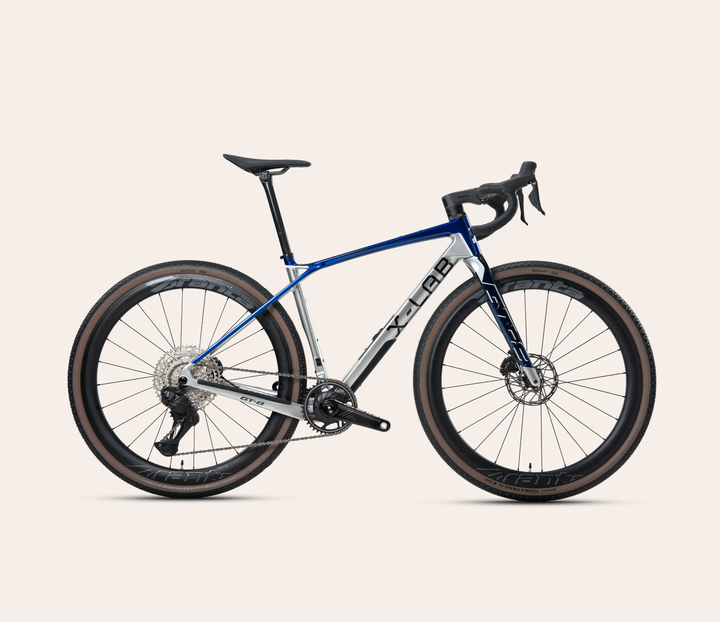 X-LAB GT8 Shimano GRX Di2 gravel bike in Slipstream, full bicycle drive-side view on a pale warm-neutral background