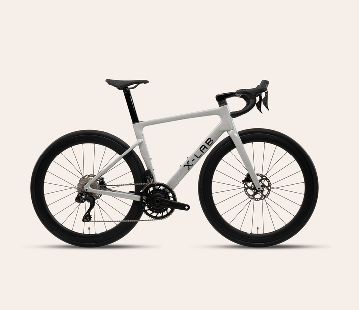 X-LAB RS7 Shimano 105 Di2 road bike in Angel Wing White on a pale warm neutral background