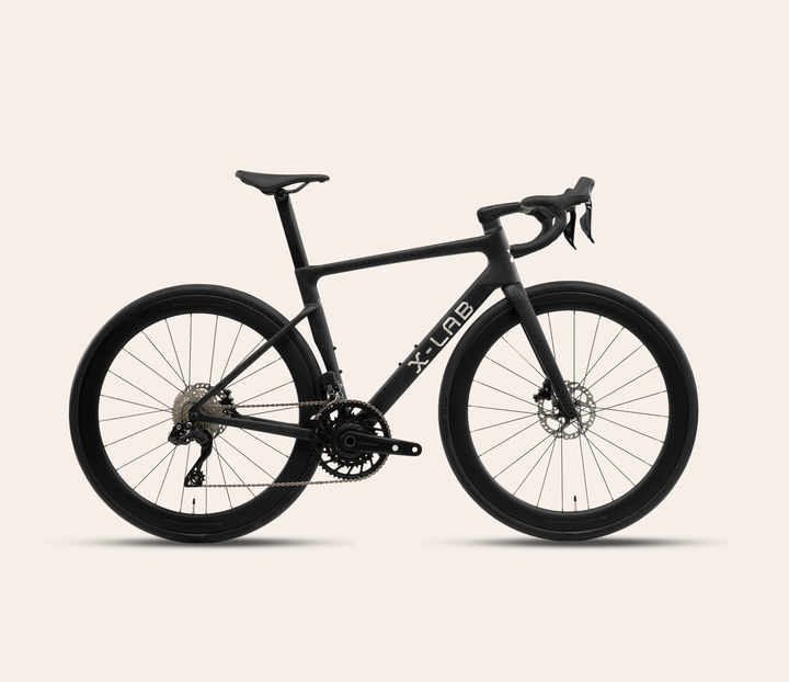 X-LAB RS7 Shimano 105 Di2 road bike in Singularity Black on a pale warm neutral background